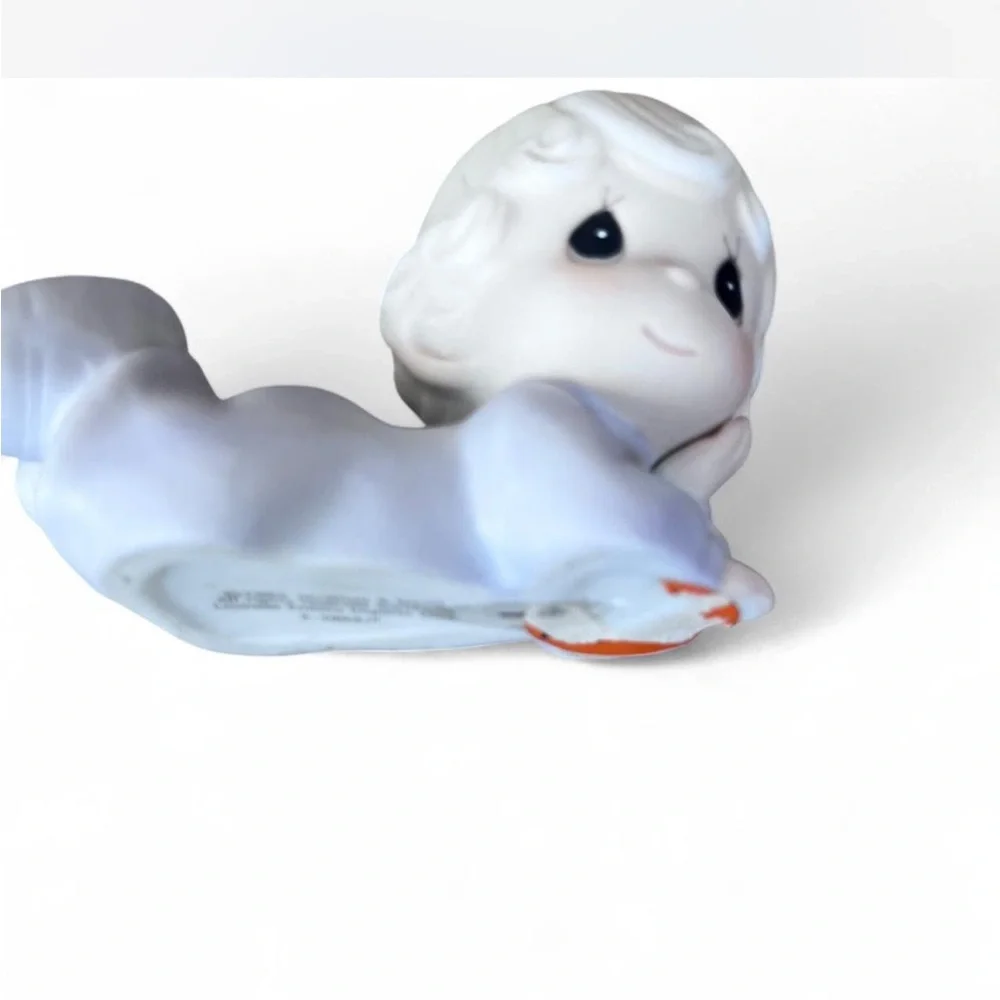 Adorable Precious Moments little girl lying down figurine in excellent condition